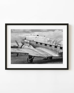 Weathered US Air Force aircraft on grass in black and white