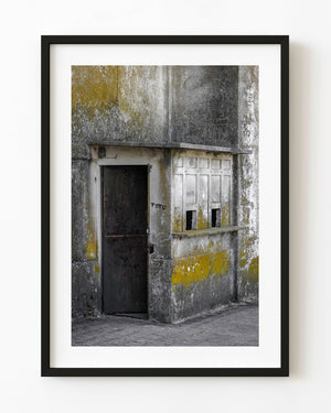 Weathered bullring ticket booth with faded yellow paint in Uruguay