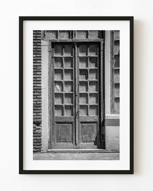 Weathered wooden double doors in Uruguay photographed in black and white
