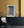 Tall wooden double doors with worn paint and geometric window grids