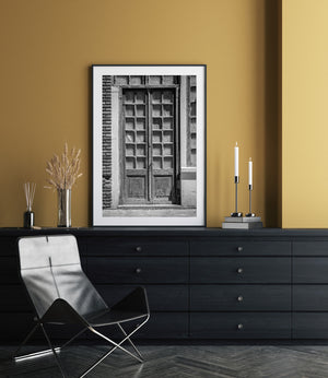 Tall wooden double doors with worn paint and geometric window grids