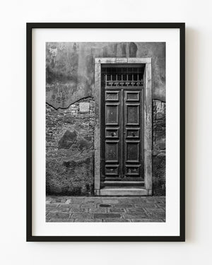 Weathered Venice wooden door and exposed brickwork in black and white