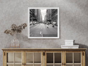 West 39th Street cityscape with people carrying umbrellas in monochrome