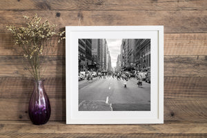 Black and white New York street photograph with crosswalks and urban traffic