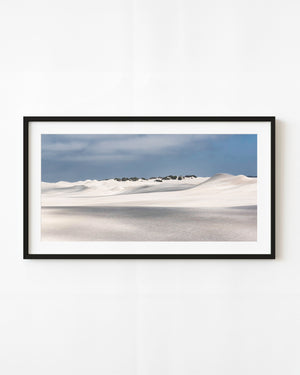 White sand dunes beneath a blue-grey sky in Western Australia