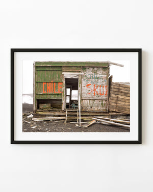 Weathered wooden cabin with orange Chile lettering at Whalers Bay Antarctica