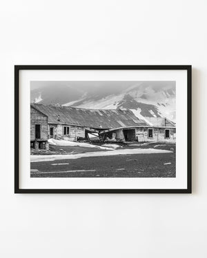 Collapsing Whalers Bay building surrounded by snow in black and white