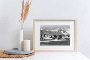 Whalers Bay ruins beneath snow covered hills in monochrome