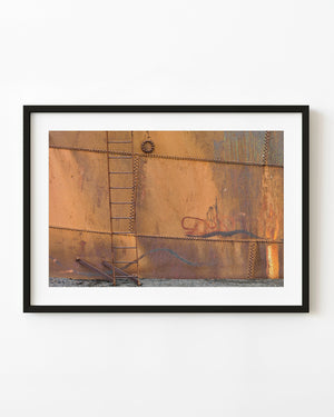 Rusted tank ladder and riveted orange metal at Whalers Bay Antarctica
