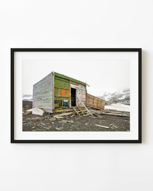 Weathered green cabin with orange Chile lettering at Whalers Bay Antarctica