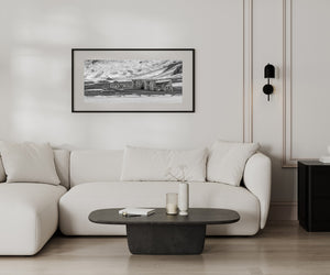 Monochrome Antarctic scene with historic structures and ice