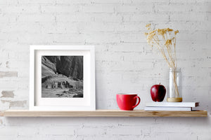 Black and white canyon photograph showing ruins on two levels