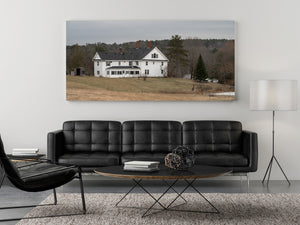 Colour photograph of a rural Maine house beneath an overcast sky