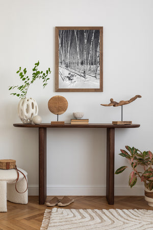 Snow covered ground and vertical birch lines