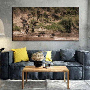 Dust rising as wildebeest gather above a river crossing