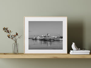 Quiet harbour with tugboats and a larger ship in the background