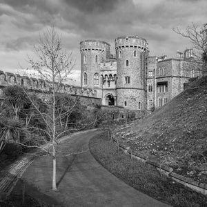 Twin round towers of Norman Gate above a curving garden path