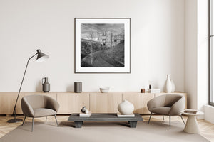 Black and white castle photograph with battlements and a winding garden path