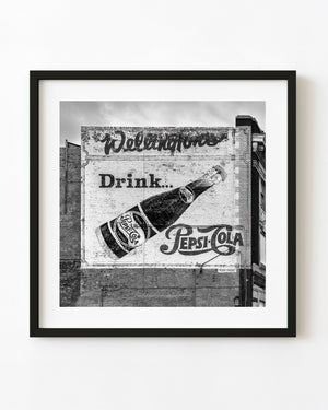 Vintage Pepsi Cola advertisement painted on a Winnipeg brick wall in black and white
