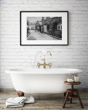 Snowy lane with brick and wood buildings in Norway