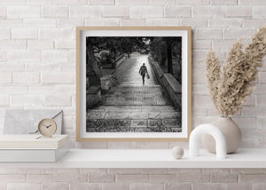 Black and white Dubrovnik scene with broad stone steps and a lone pedestrian