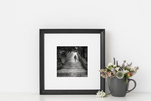 Candid photograph of a woman ascending an old stone walkway in Dubrovnik