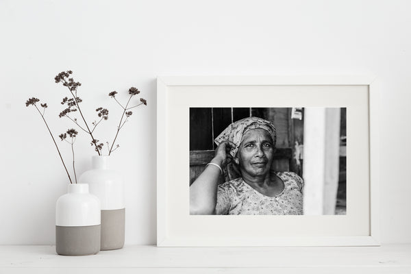 Woman in India resting in her store