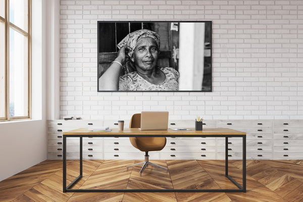 Indian woman resting in her shop black and white