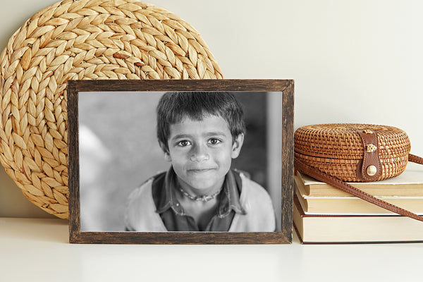 Young boy smiling at school in Odanadi