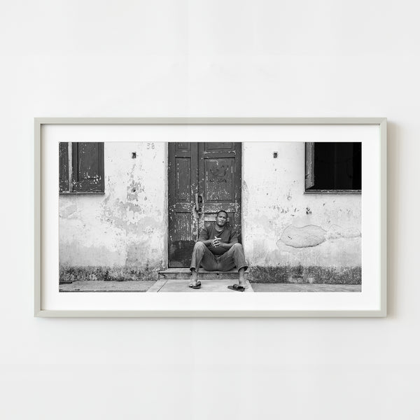 Man sitting on doorstep in Cuba