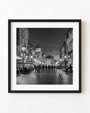 Zagreb clock tower and illuminated evening street in black and white