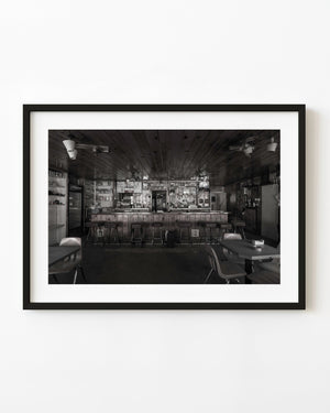 Empty diner counter and stools in Zion photographed in black and white