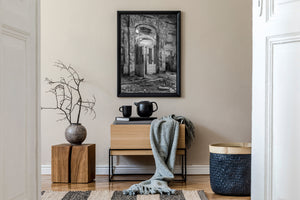 Monochrome architectural photograph of a crumbling hotel doorway