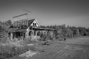 Weathered roadside motel with empty parking lot in Northern Ontario