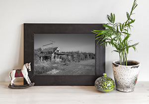 Black and white photograph of a decaying abandoned motel
