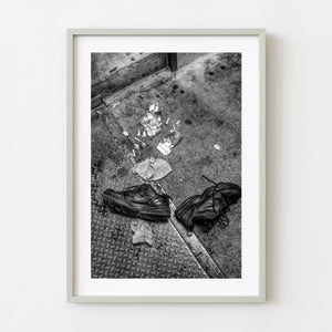 Abandoned black shoes on a Manhattan street in black and white