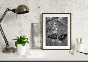 Urban street scene with two abandoned shoes and scattered debris