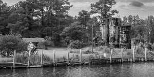 Black and white photograph of weathered marina fuel tanks in Florida
