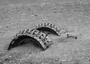Half buried machinery tires in Antarctica black and white