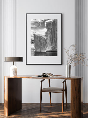 Black and white polar landscape with iceberg cliffs and ocean