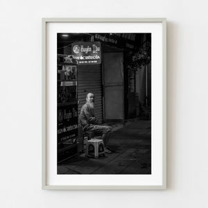 Black and white portrait of an elderly bearded man on a Hanoi street