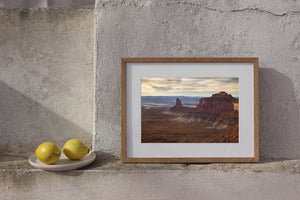 Wide desert canyon view with layered cliffs and weathered buttes