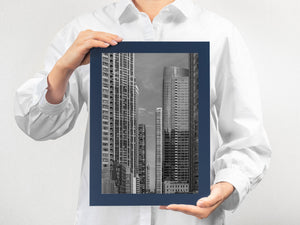 Tall Chicago buildings surrounding a small distant high-rise tower