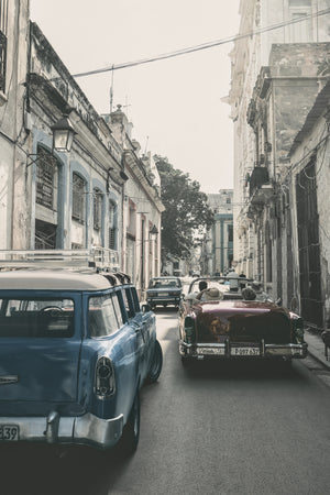View from a car behind a red convertible in Havana