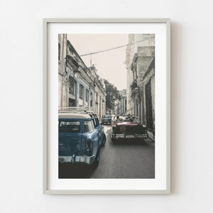 Classic cars driving through a street in Old Havana Cuba