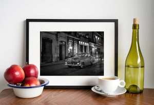 Black and white Havana street scene with a vintage car