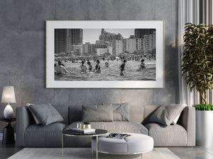 Soft foreground swimmers and sharply detailed beach crowd in Miami