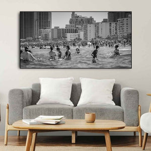 Panoramic South Beach scene filled with people in the ocean and on the sand