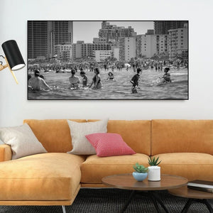 Urban beach crowd with ocean waves and Miami Beach architecture