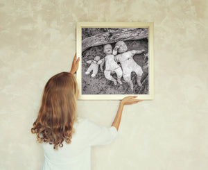 Damaged baby dolls beneath fallen weathered timber